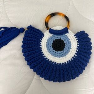 Evil eye woven clutch